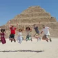 Tourists exploring the Great Pyramids of Giza, Dahshur pyramids, and Saqqara step pyramid, discovering the wonders of ancient Egypt monuments.