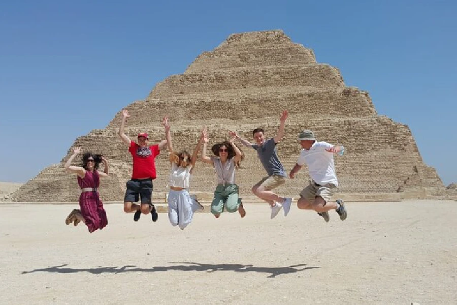 Tourists exploring the Great Pyramids of Giza, Dahshur pyramids, and Saqqara step pyramid, discovering the wonders of ancient Egypt monuments.