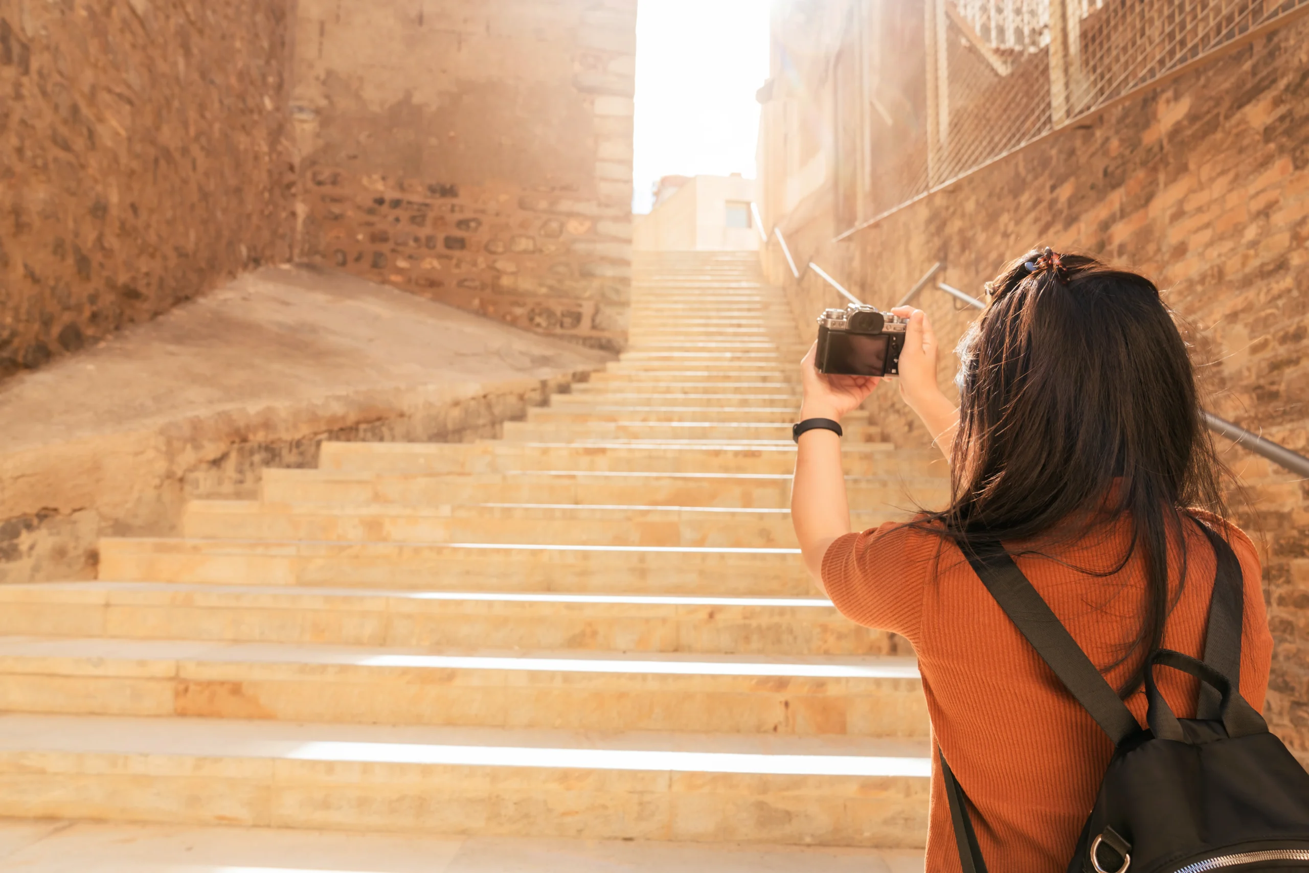 attractive asian female traveller tourism hand use camera sightseeing old stone stair hallway cartagena spain with happiness cheerful travel journey concept scaled